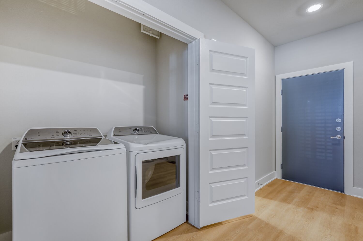 Laundry room with white appliances