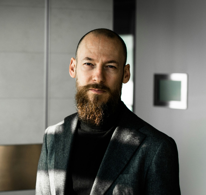A man with a beard wearing a suit.