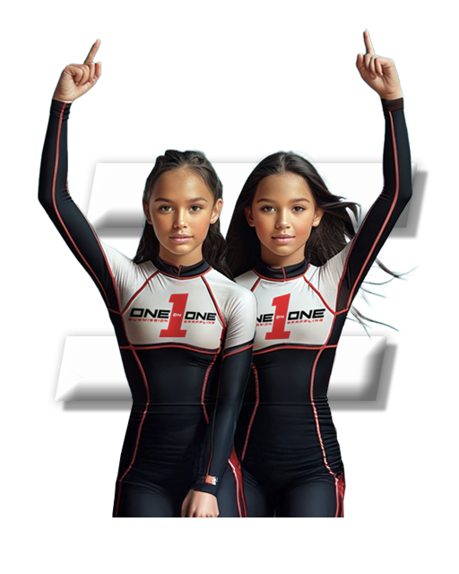 Two youth Jiu-Jitsu athletes standing in front of the letter I.