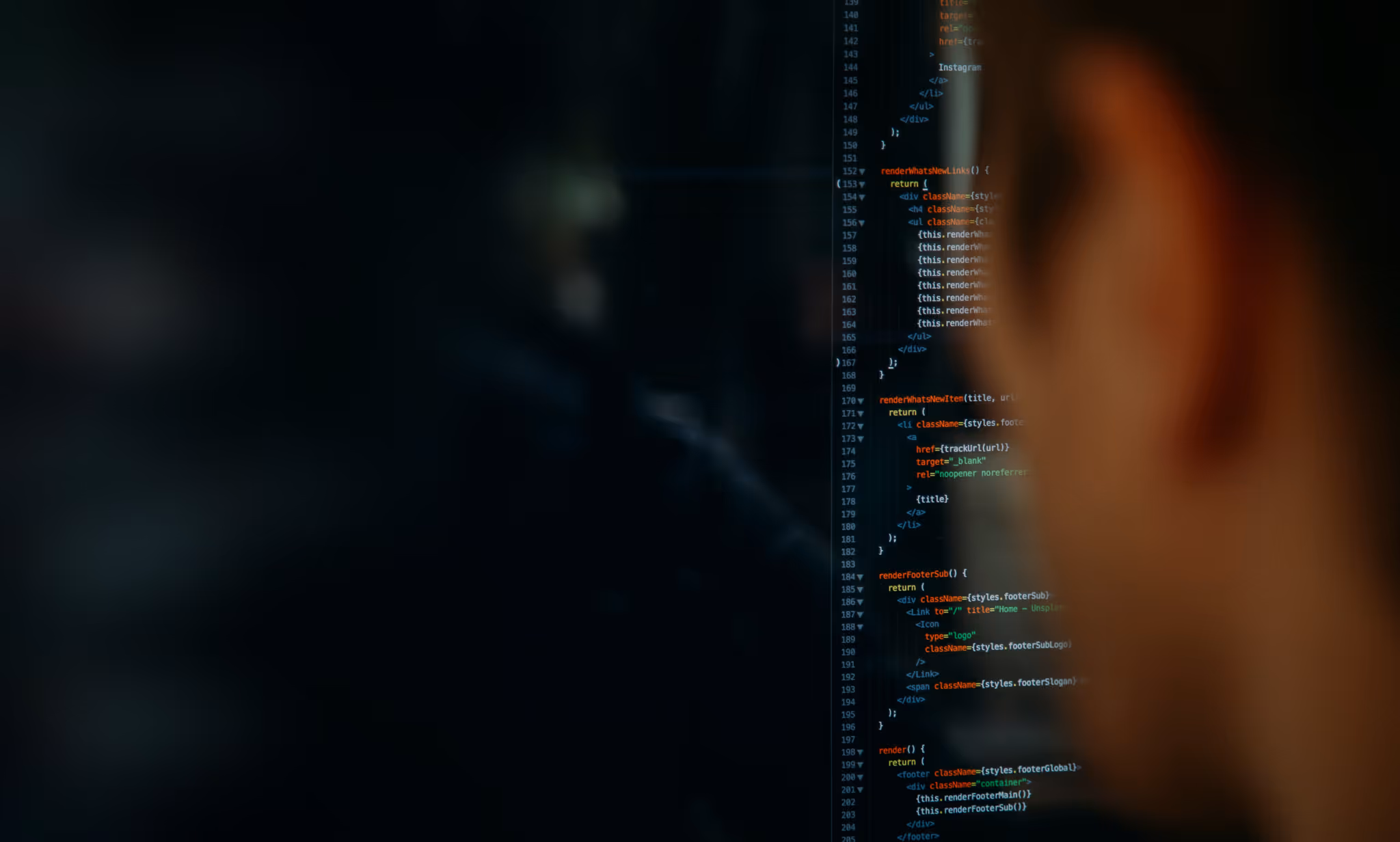 Man looking at code in a darkroom with blur effect