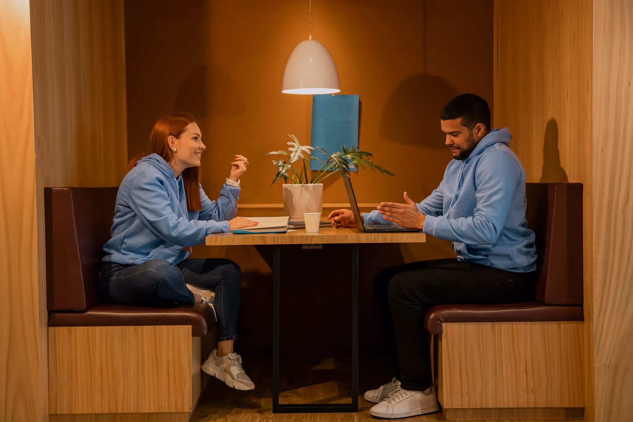 Two people working on their computers at a coffee shop