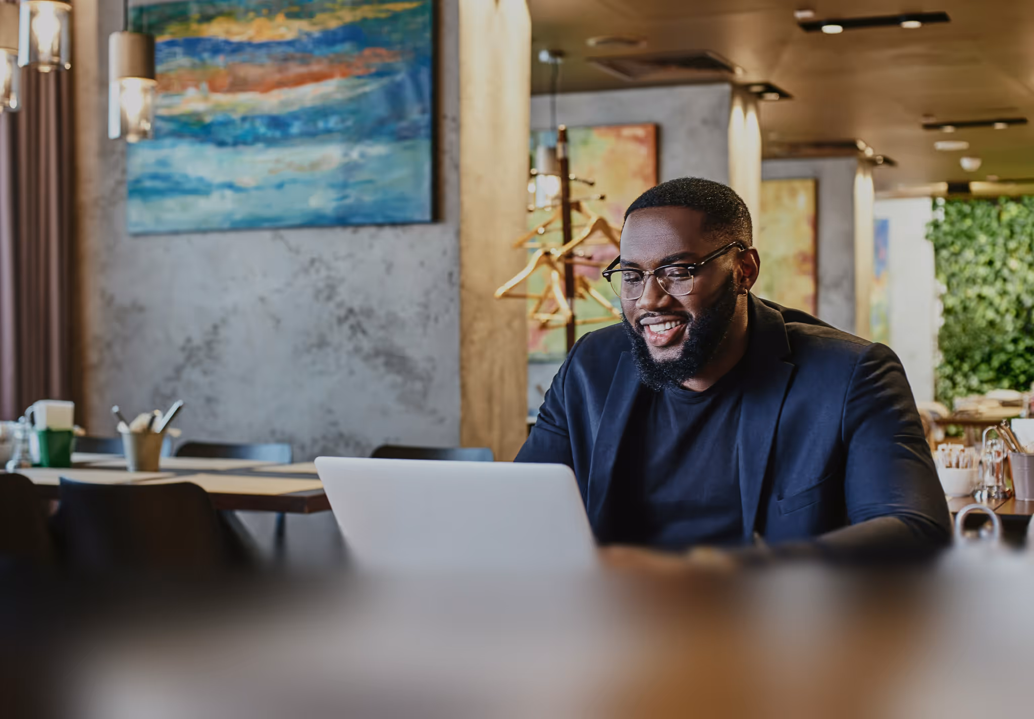 Blur effect on man working at his computer in a stylish office