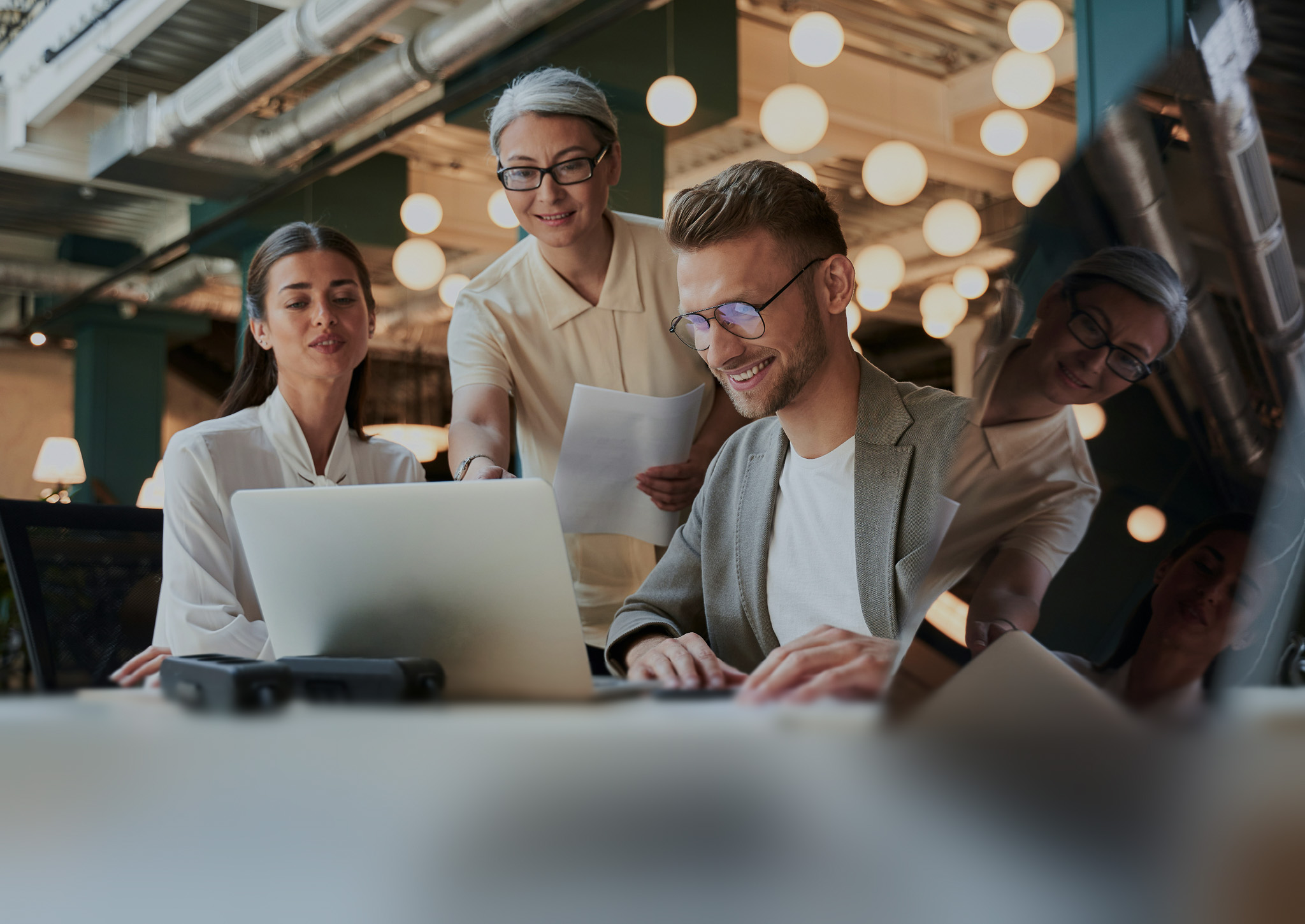 Blur effect on an image of three people working together on a computer