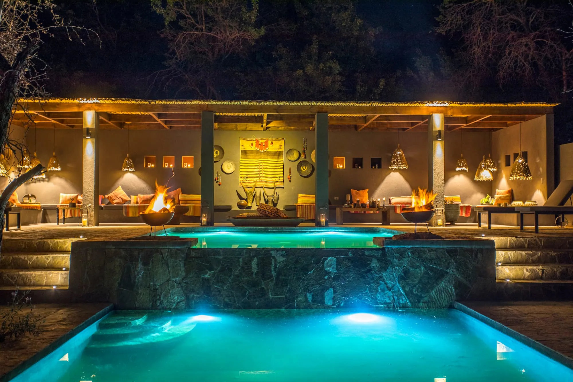 Lodge lounge and heated pool at dusk near San Pedro de Atacama, Chile