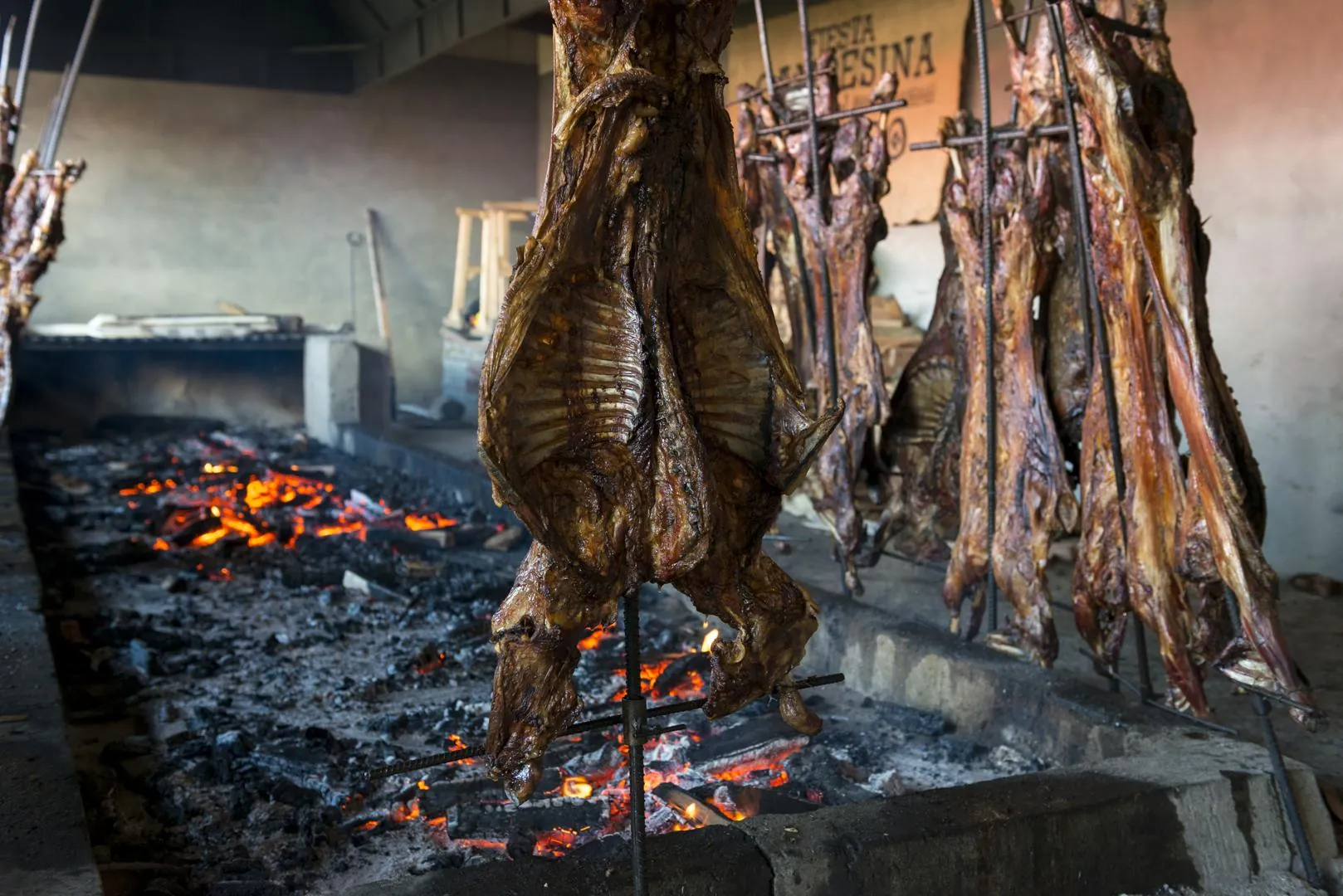 Lamb slow-roasting over an open fire for a traditional Patagonian asado dinner