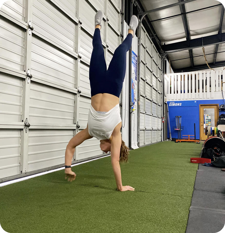 pt patient doing handstand walk - crossfit pt services