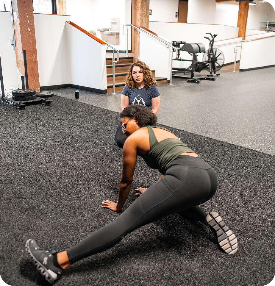 paulina working with patient stretching - outdoors athletes service