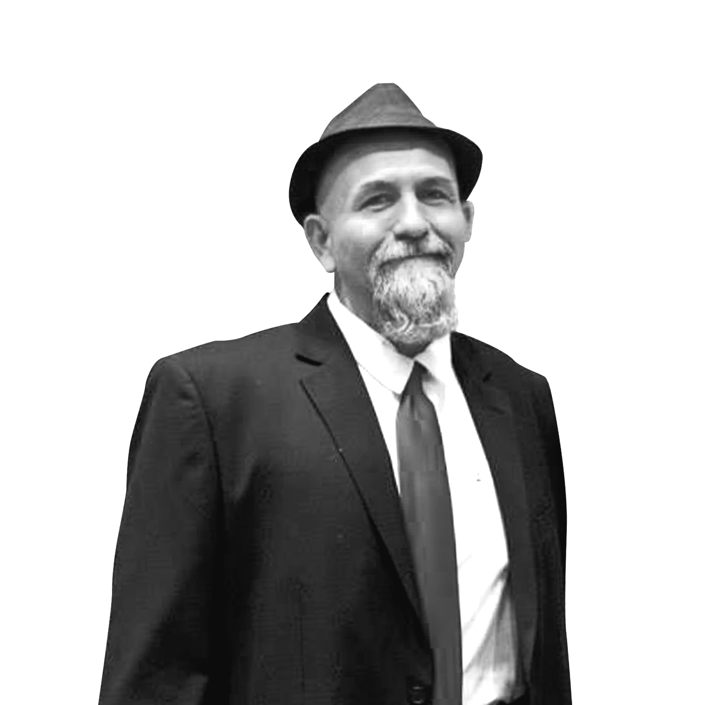 Smiling man with a beard wearing a fedora hat, suit jacket, white shirt, and tie.