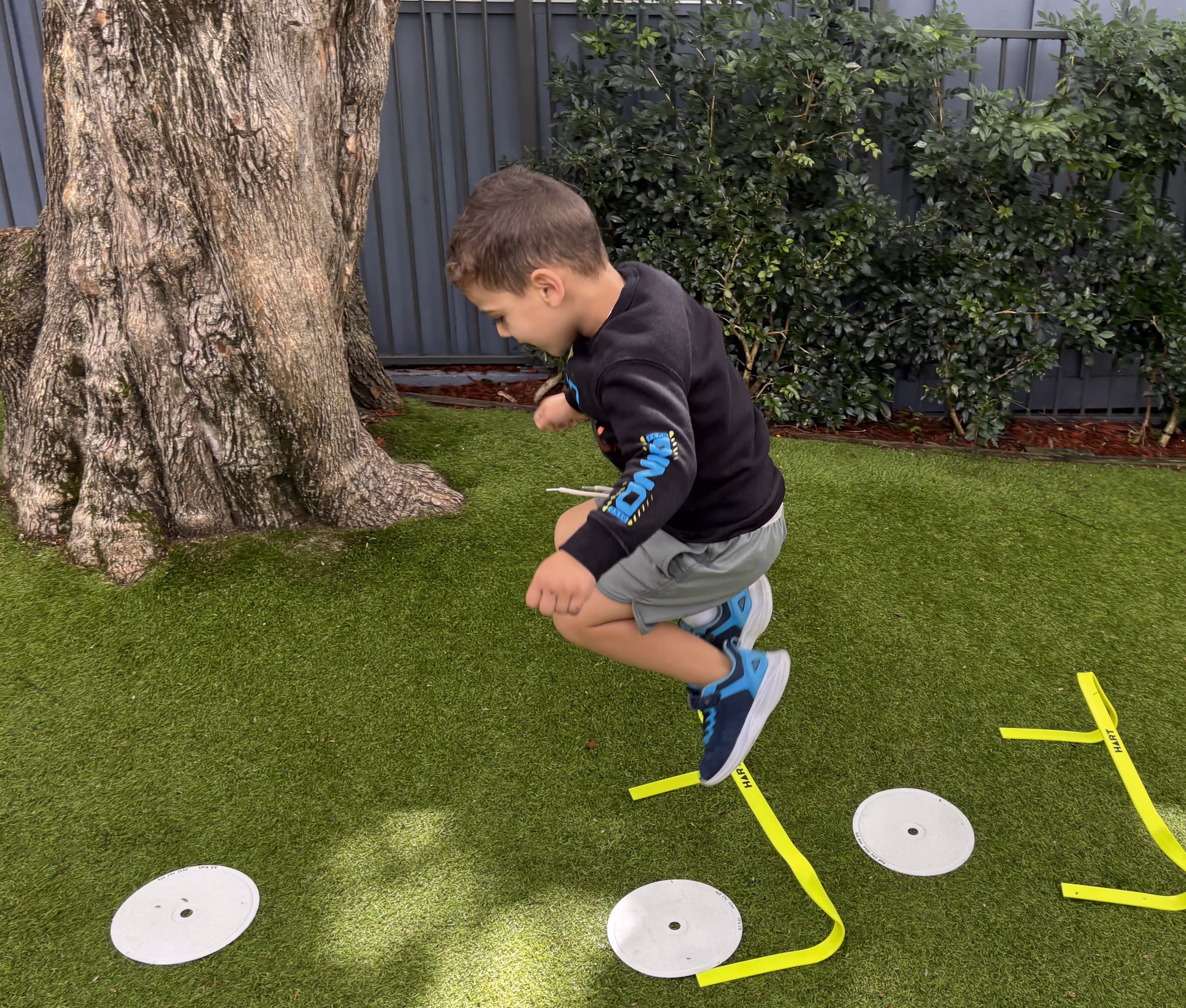 A kid doing physical exercise outdoor