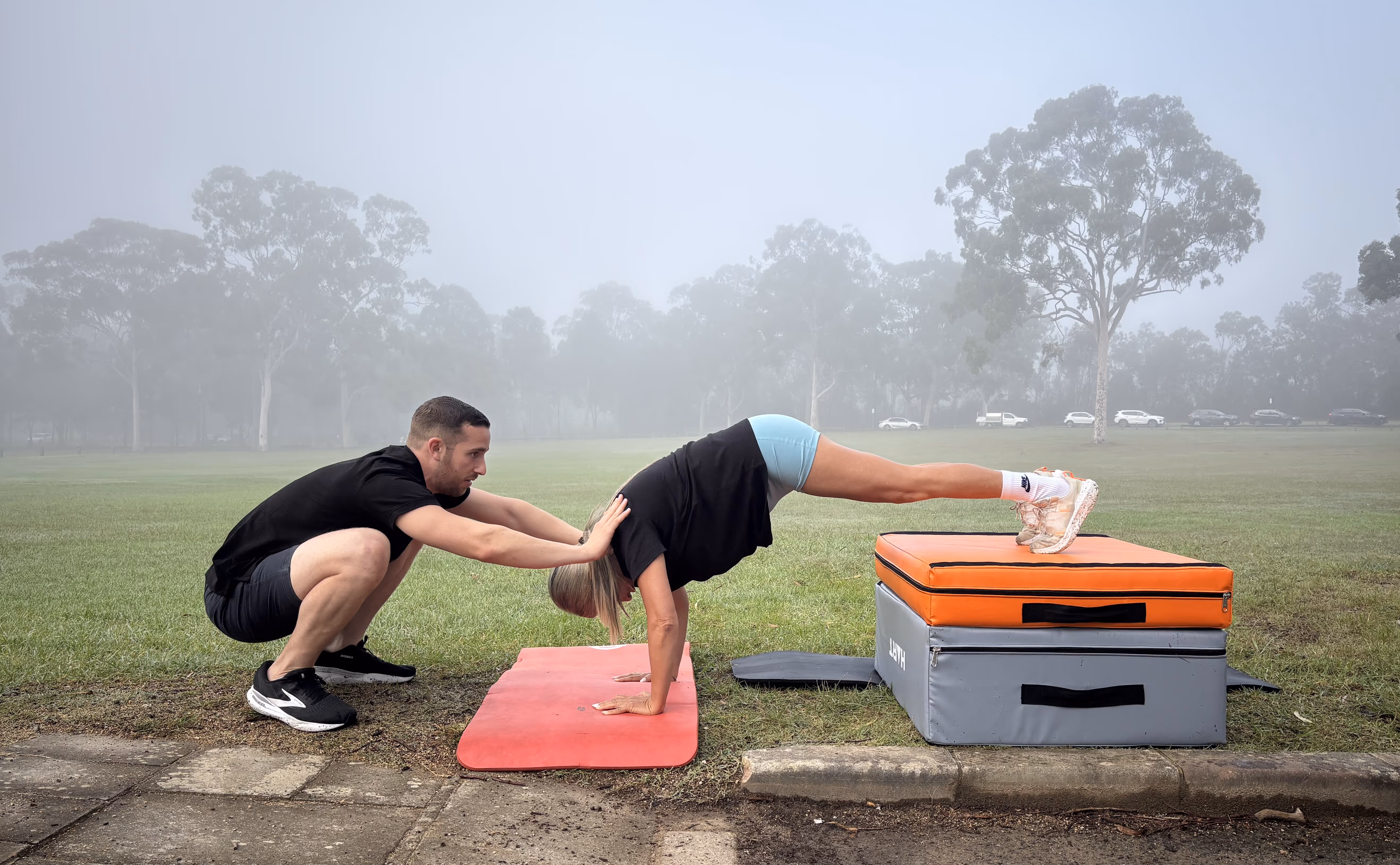 Coach helps kid to do exercise