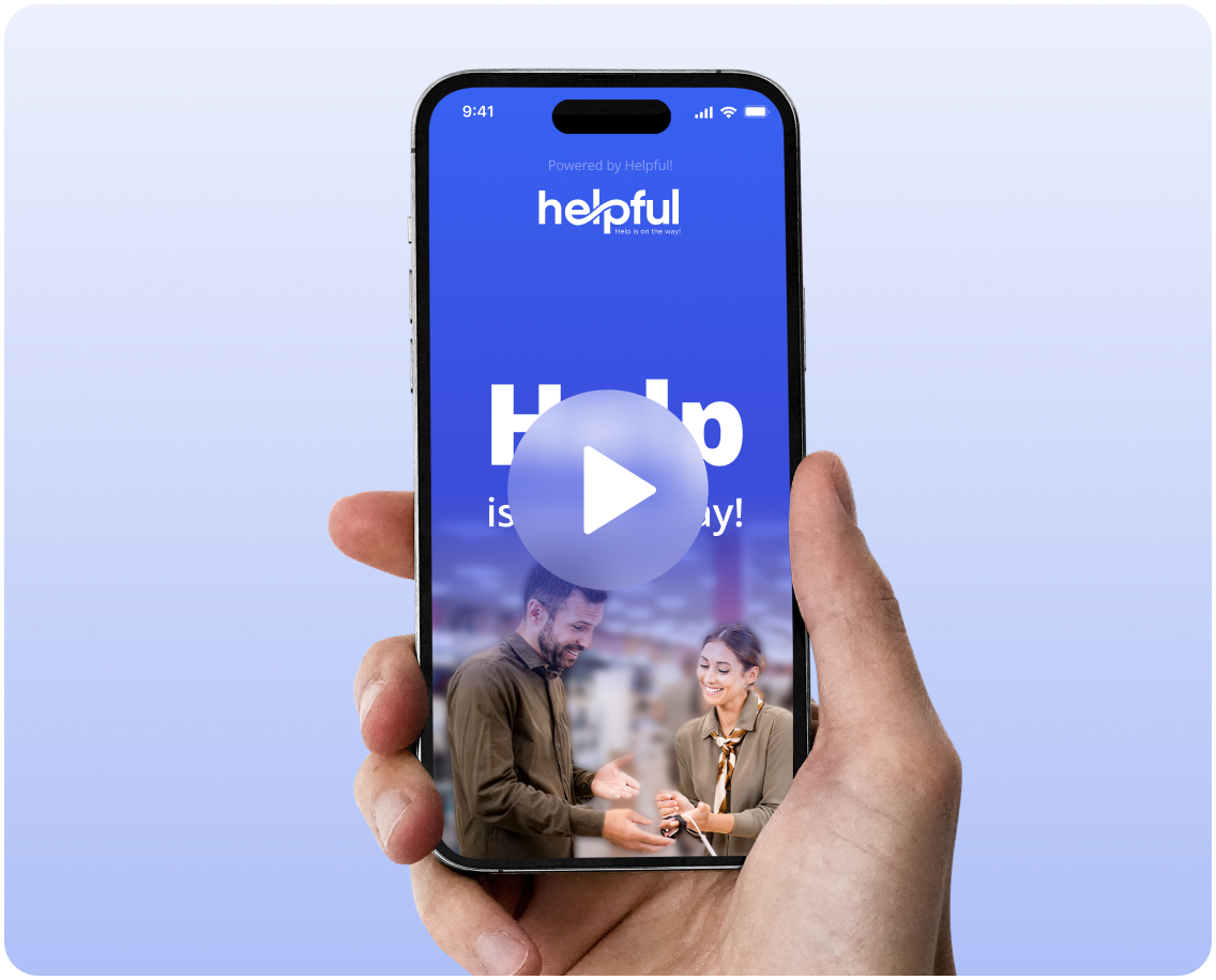 Hand holding a smartphone displaying the Helpful app interface with a man and woman smiling and a play button overlay.