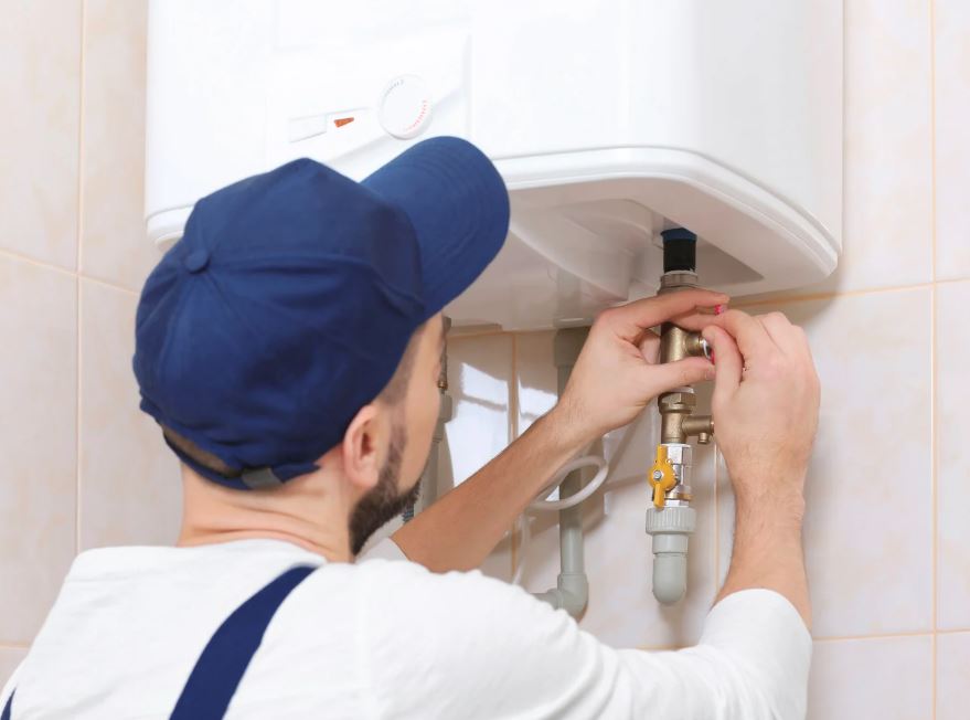 Plumber repairing a water heater