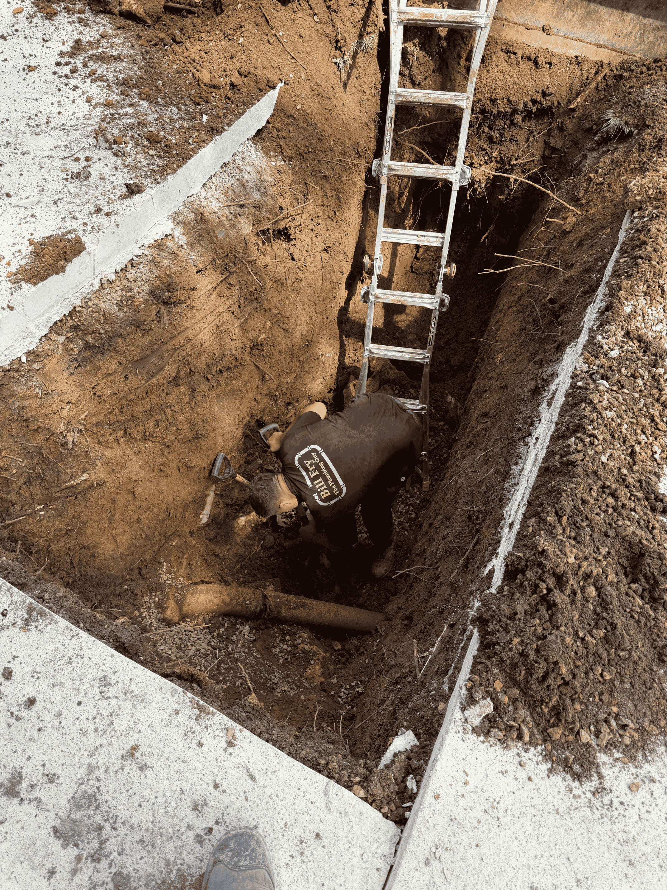 plumber excavating outside
