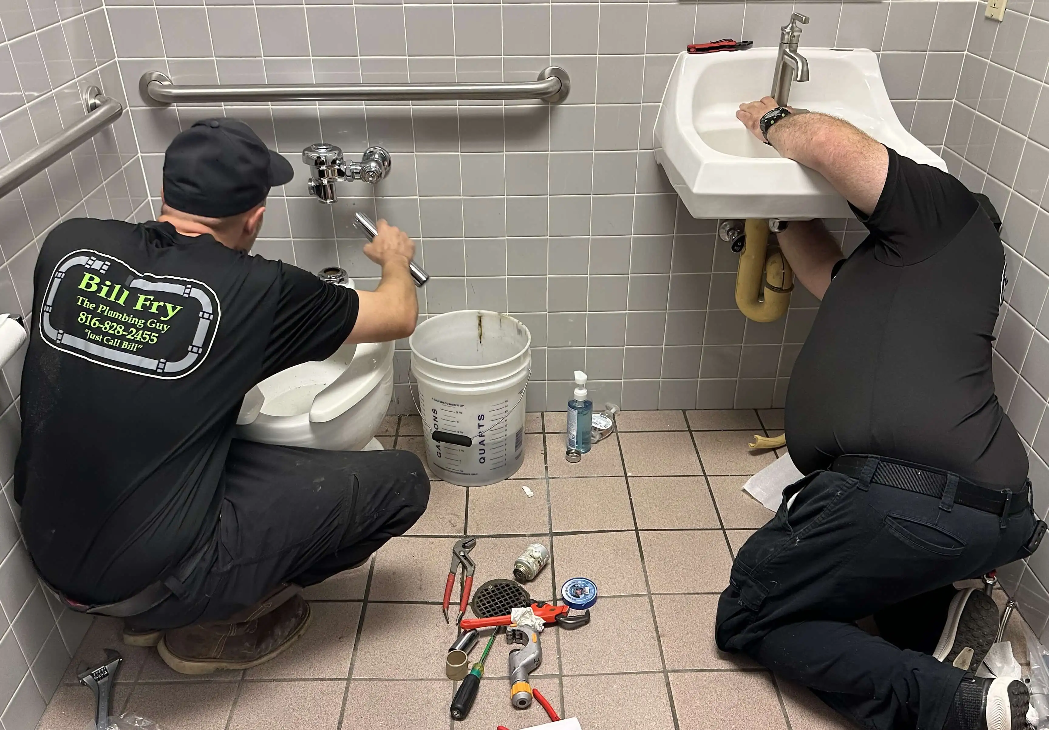 plumbers fixing a sink