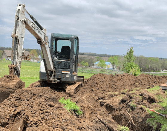 plumber excavating a yard