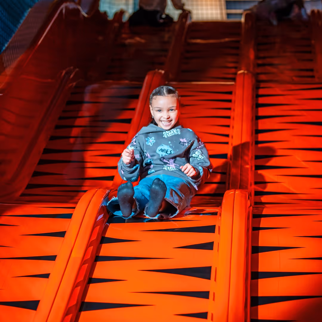 Child smiling on big slide