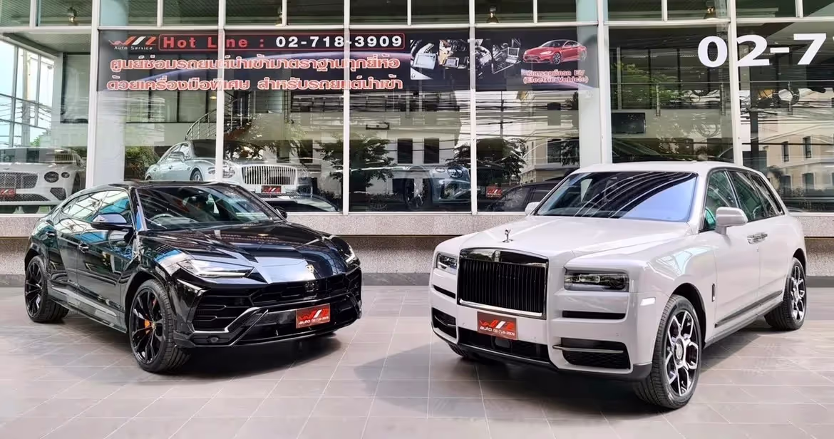 Wiz Auto's dealership featuring two cars outside, black on the left and white on the right. 