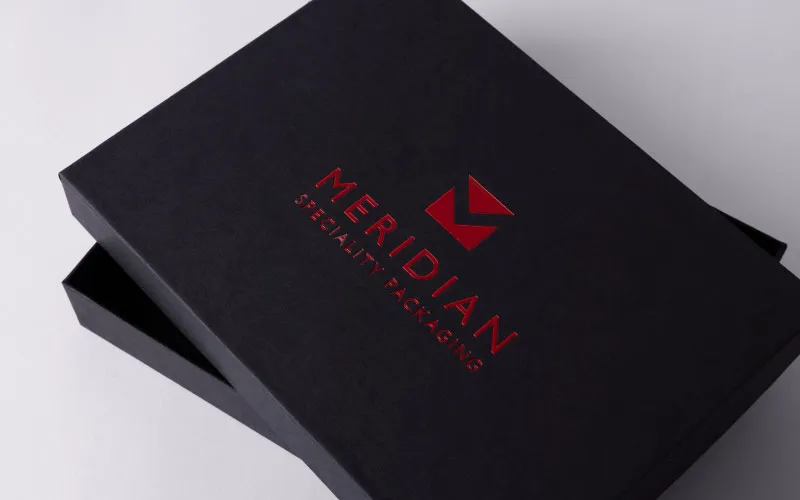 Black specialty packaging box with red Meridan logo and text on the lid.