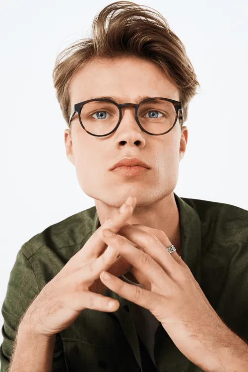 Thoughtful person with glasses resting chin on hands against white background