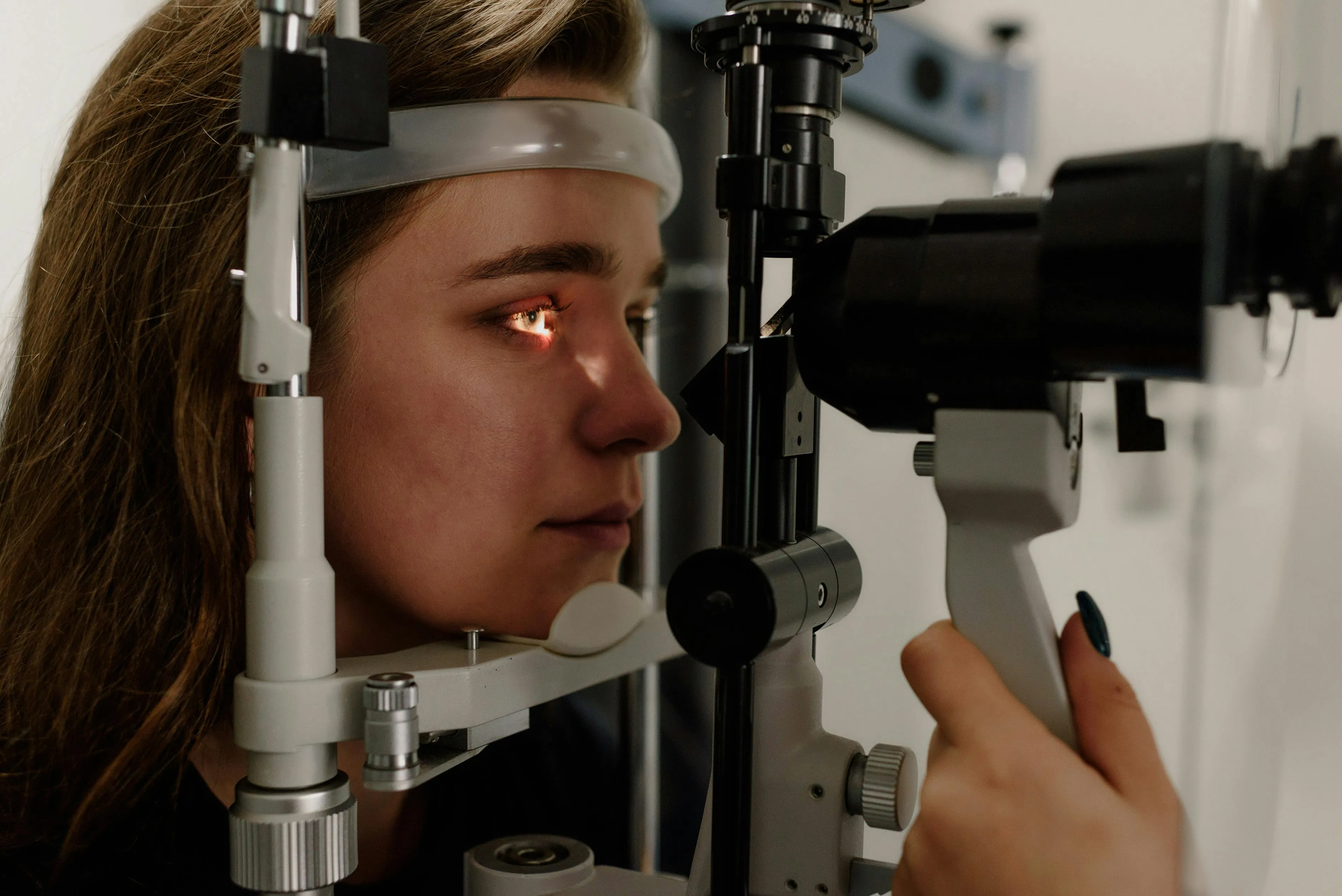 Person undergoing eye examination with professional medical equipment