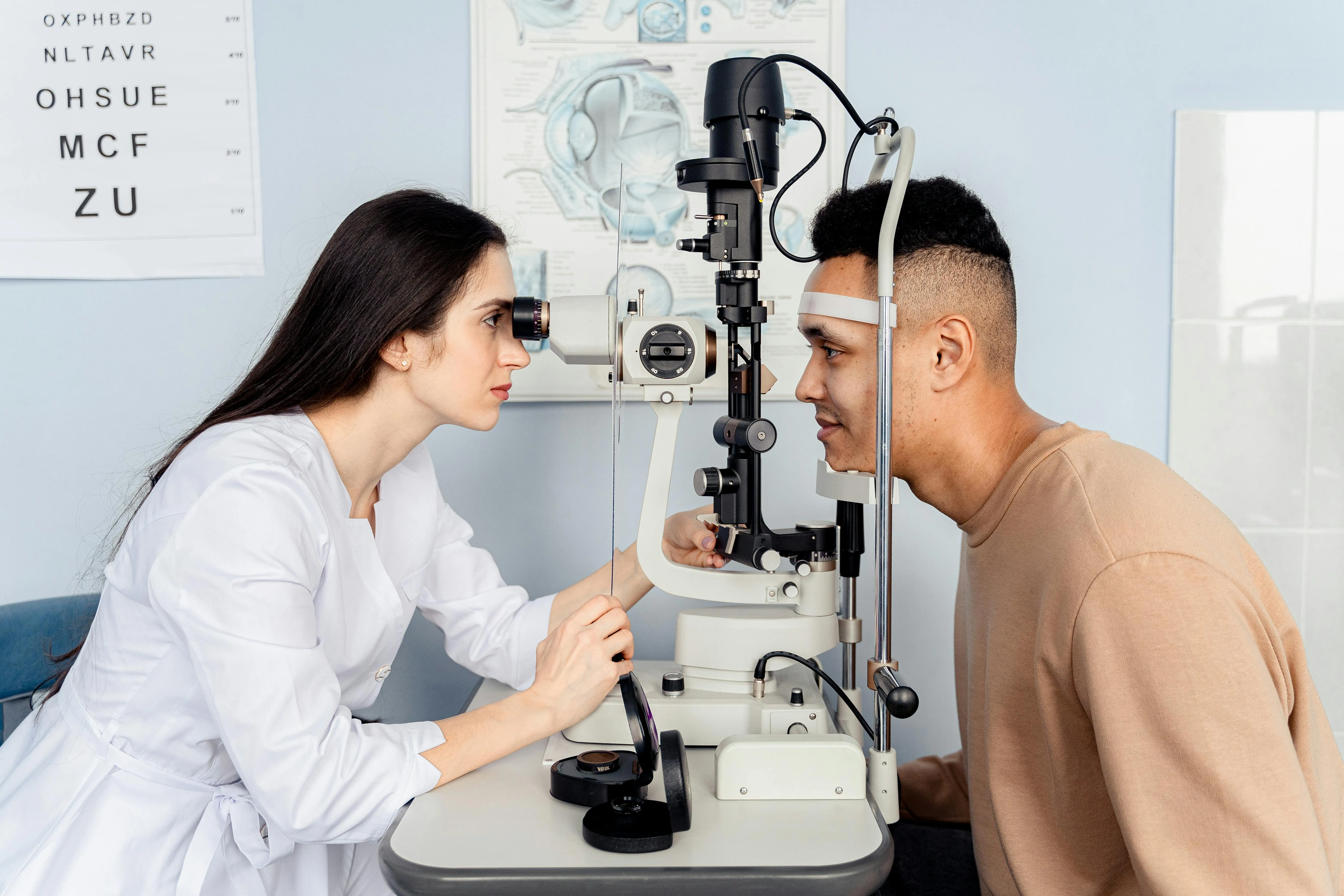 Eye doctor performs eye exam using professional slit lamp examination equipment