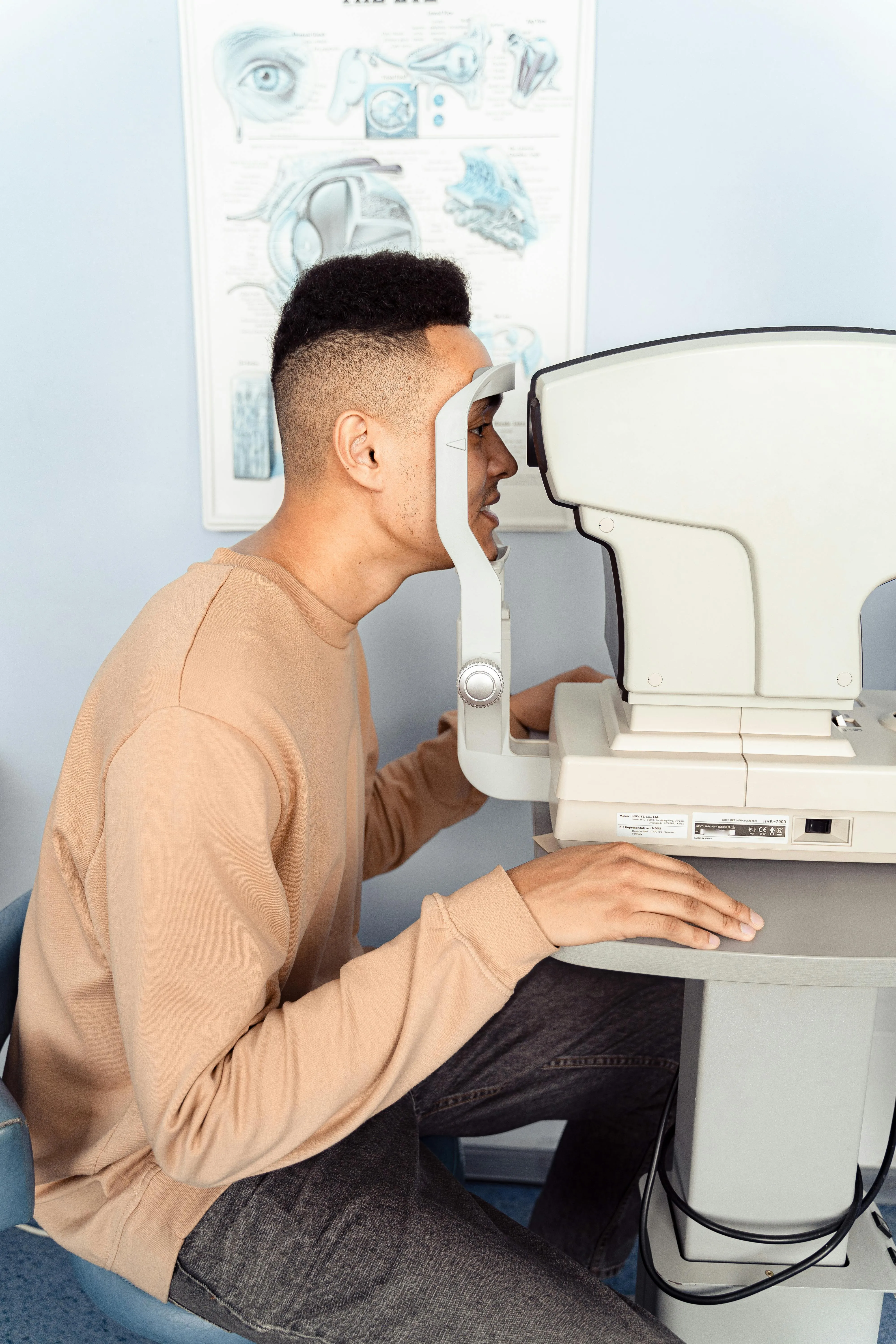 Person undergoing eye exam using professional optometry equipment