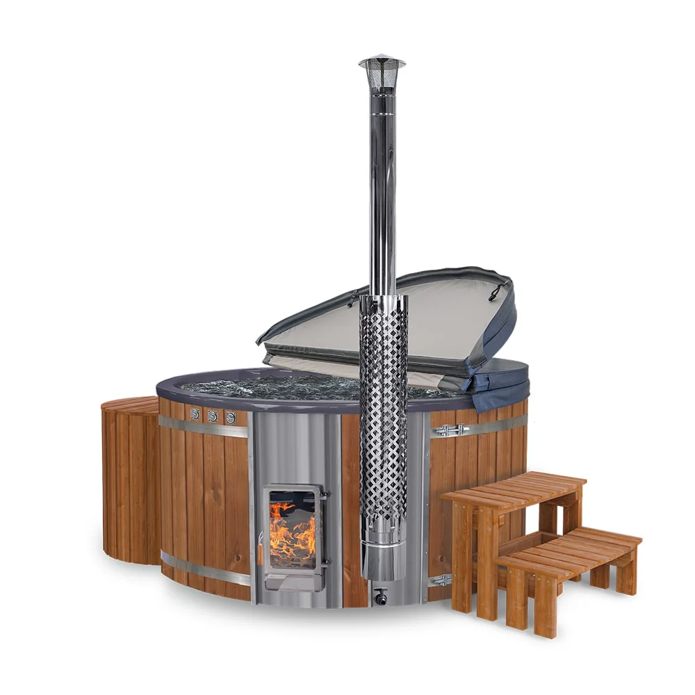 Round wooden hot tub with a grey cover partially open, a stainless steel chimney, fire burning inside the heater, and wooden steps.