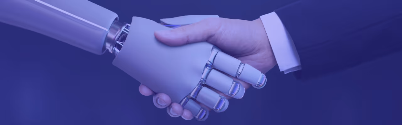 Une main humaine serre une main robotique, symbolisant la collaboration entre humains et intelligence artificielle.