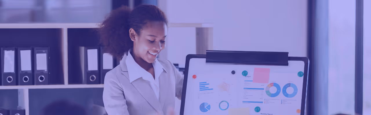 Femme présentant un tableau blanc avec graphiques et diagrammes lors d'un événement marketing.