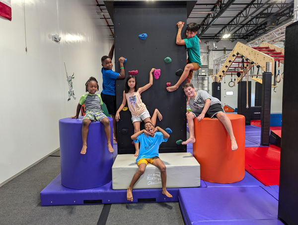 ninja kids laughing and posing on obstacles
