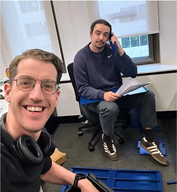A man sitting in a chair next to another man