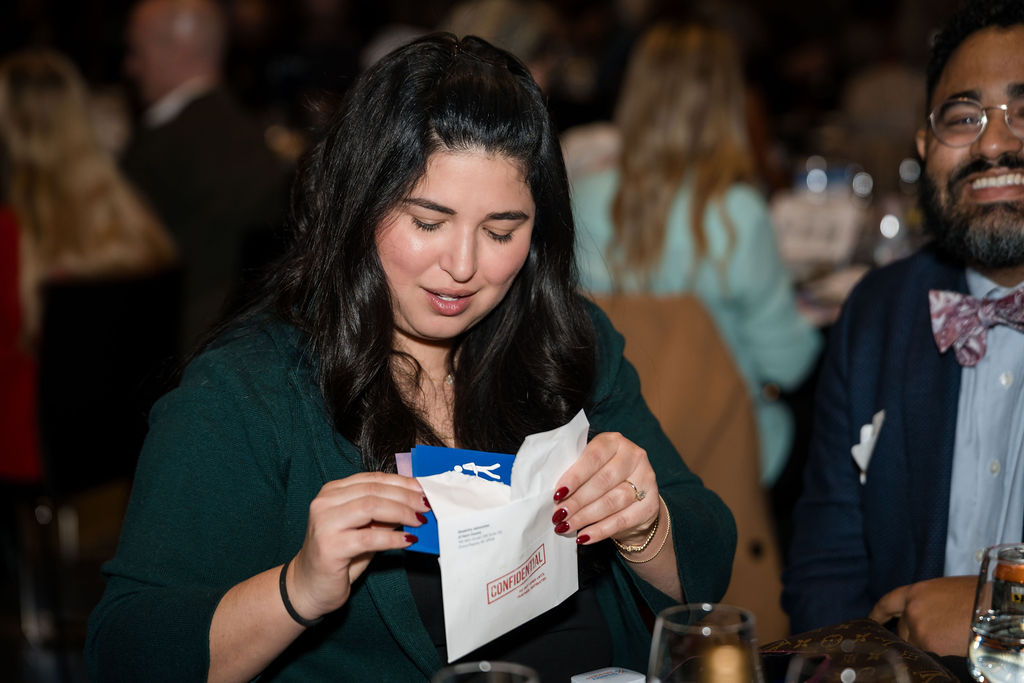 guest opening confidential envelope and taking the stickers out 
