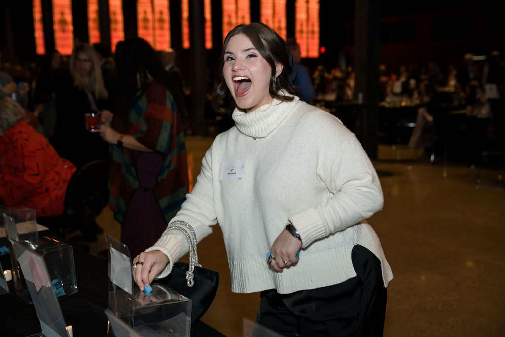 guest putting a raffle ticket into a basket 