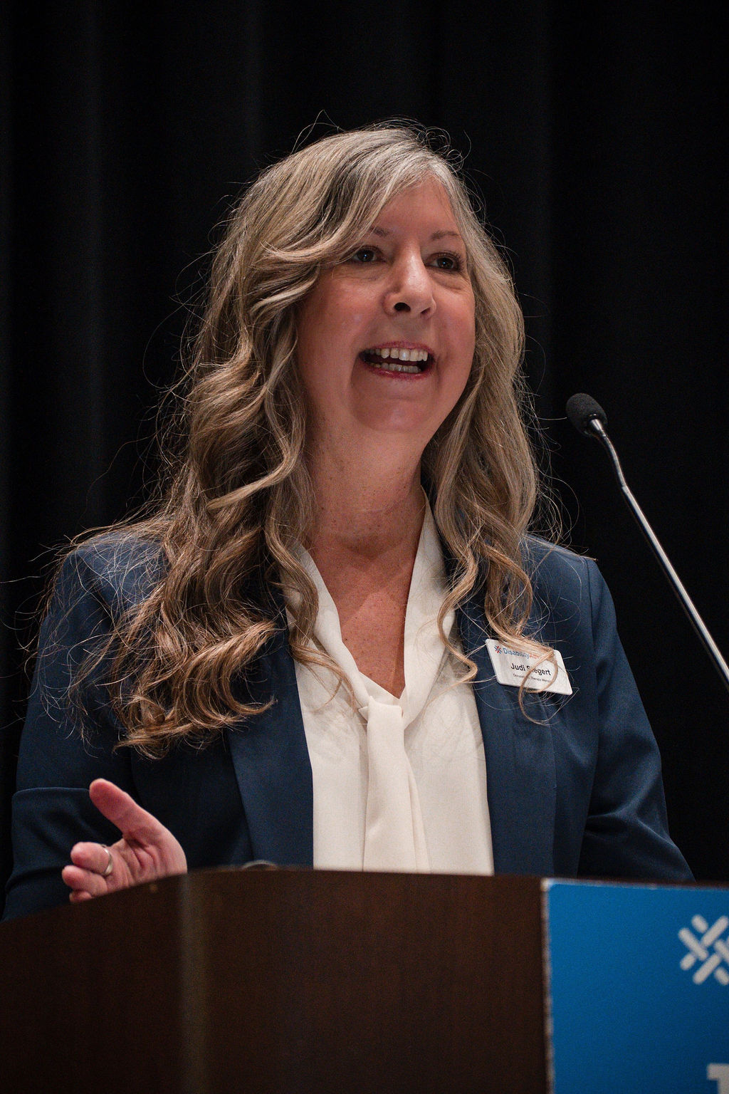 Judi speaking on stage