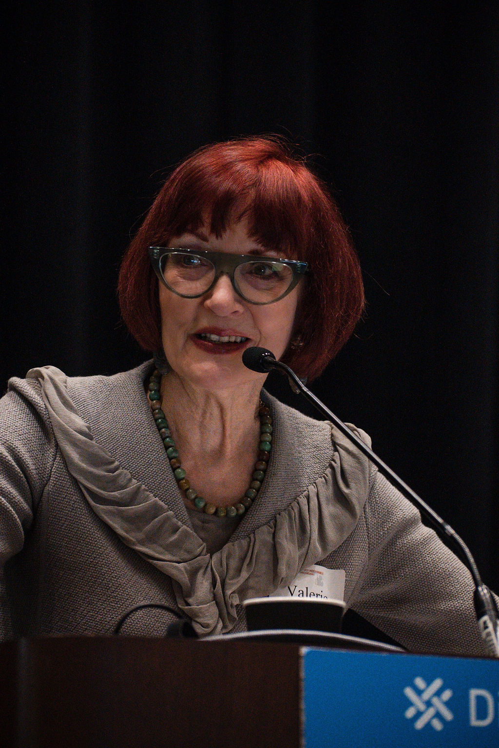 Valerie speaking on stage