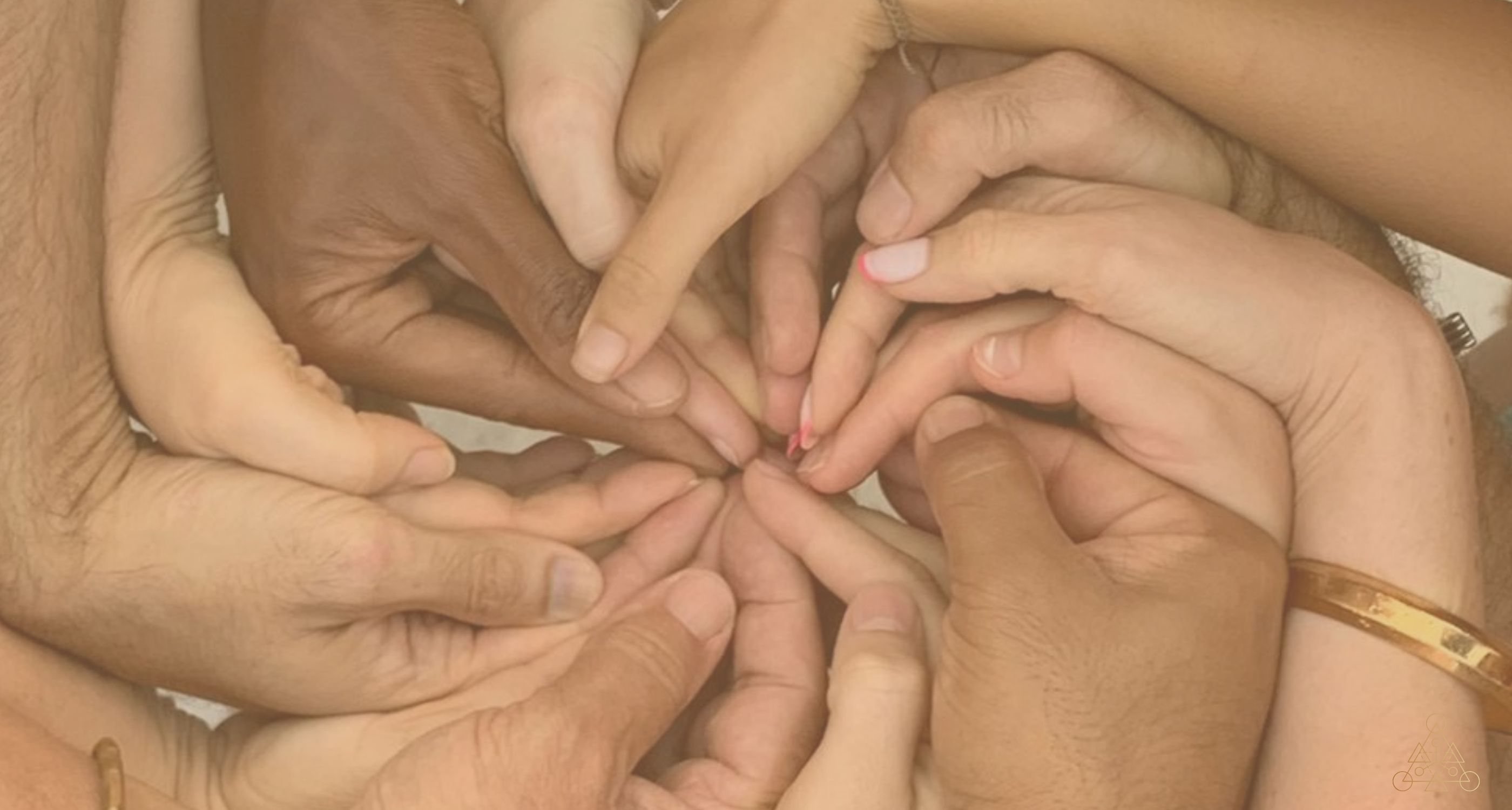 Hands resting on one another in a circle