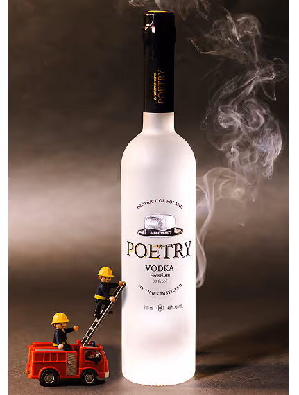 Large bottle of Poetry vodka with tiny firefighter figures on a ladder and truck spraying smoke.