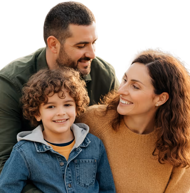 Smiling family with a young child posing together.