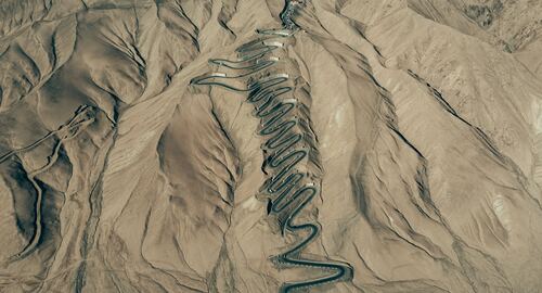 an aerial view of a mountain range with a snake