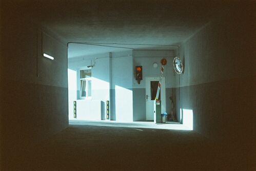an empty room with a clock on the wall
