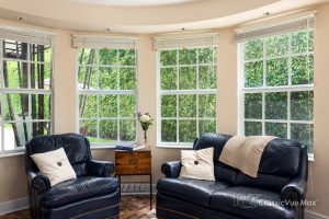 Attractive white color grilled window with having sofa in the room.