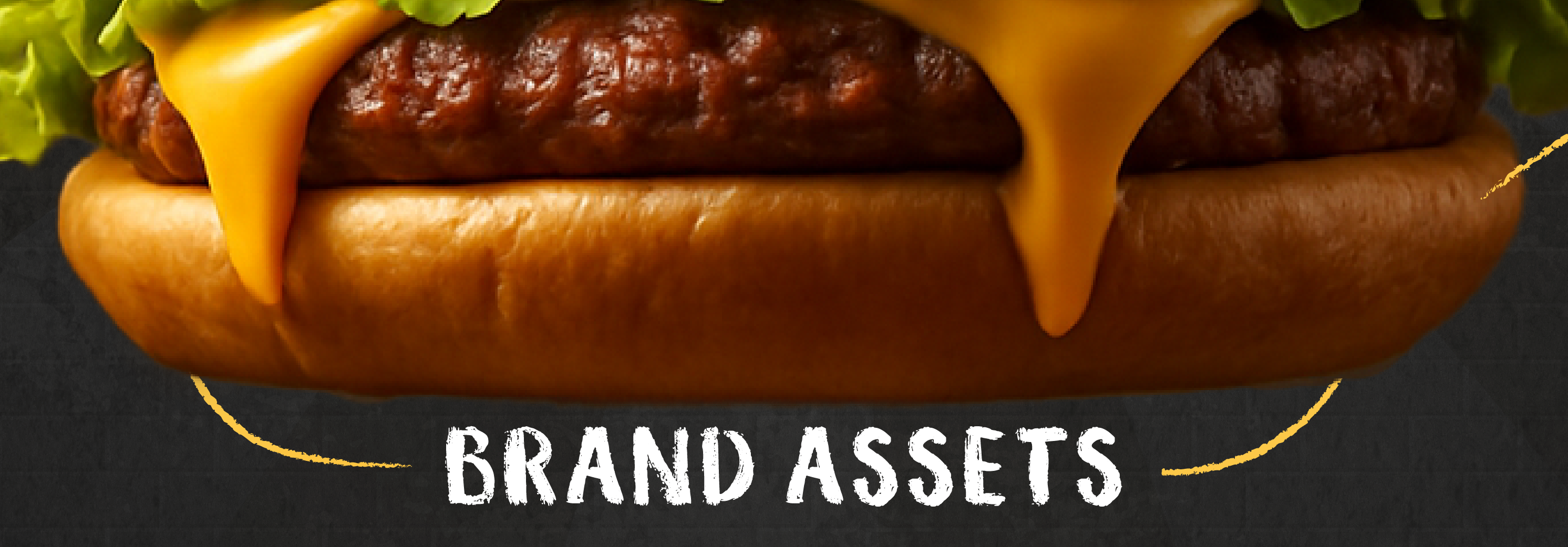 Bottom view of a burger showing melted cheese and bun representing the Brand Assets section.