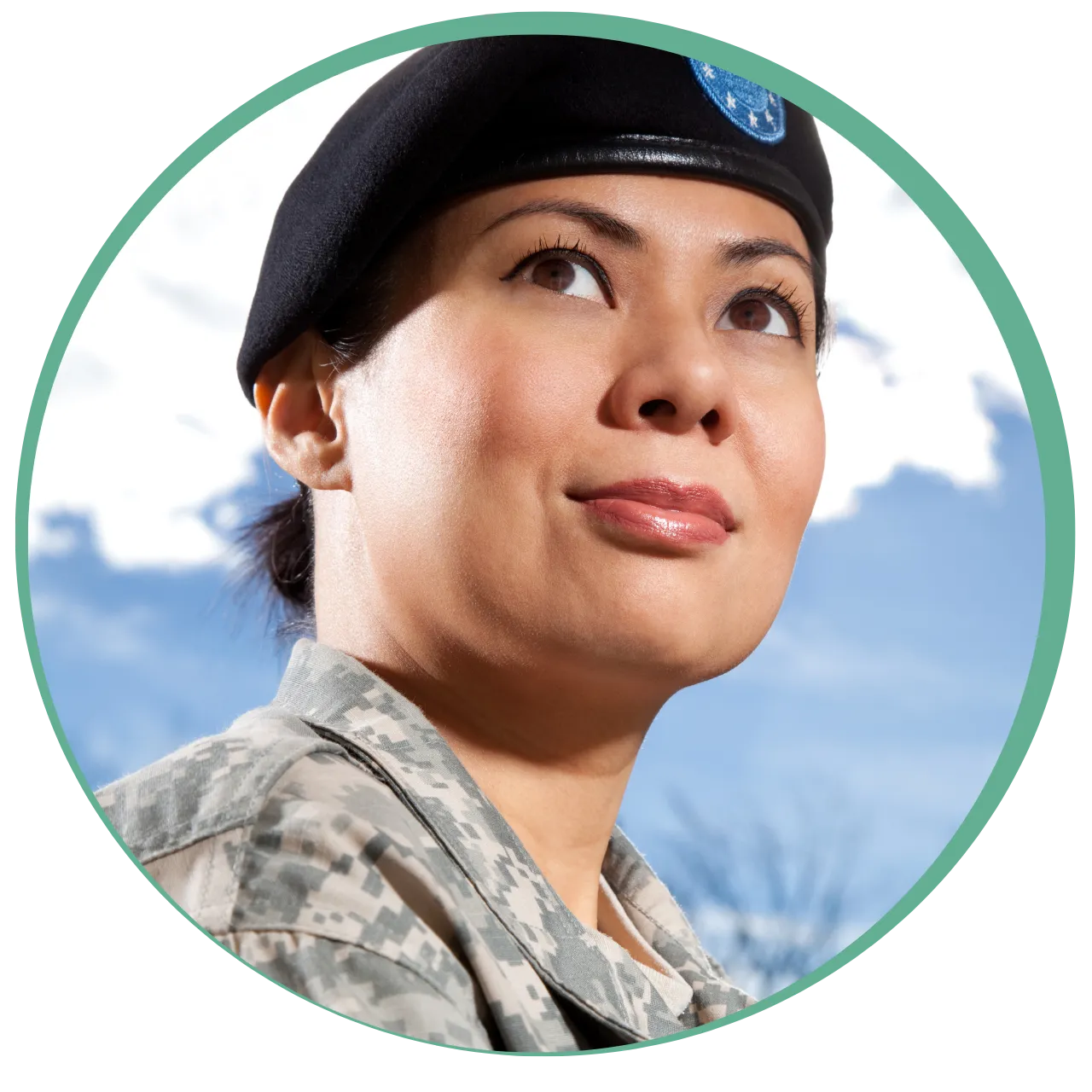 Confident female soldier wearing a military uniform and black beret looking upward against a blue sky background.