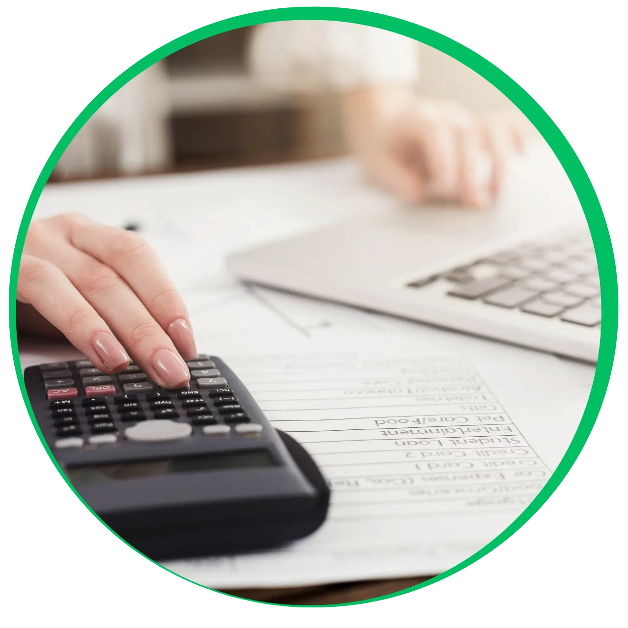 Person using a calculator with financial documents and a laptop in the background.