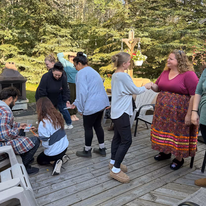 Karlees team outside shaking hands with community members