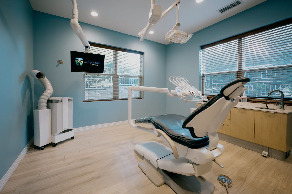 Modern dental operatory with blue accents, professional chair, and clinical equipment