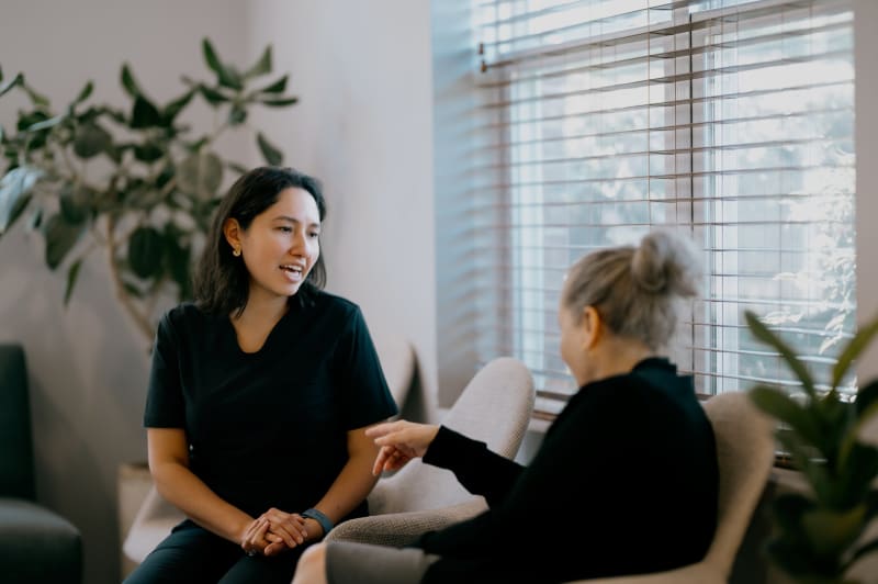 Female dentist having a consultation discussion with patient in dental office setting