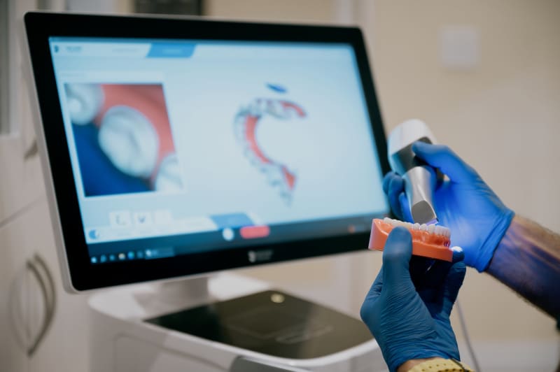 Dental professional using advanced scanning equipment for patient imaging procedure