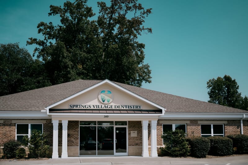 Modern dental practice exterior with brick facade and welcoming entrance