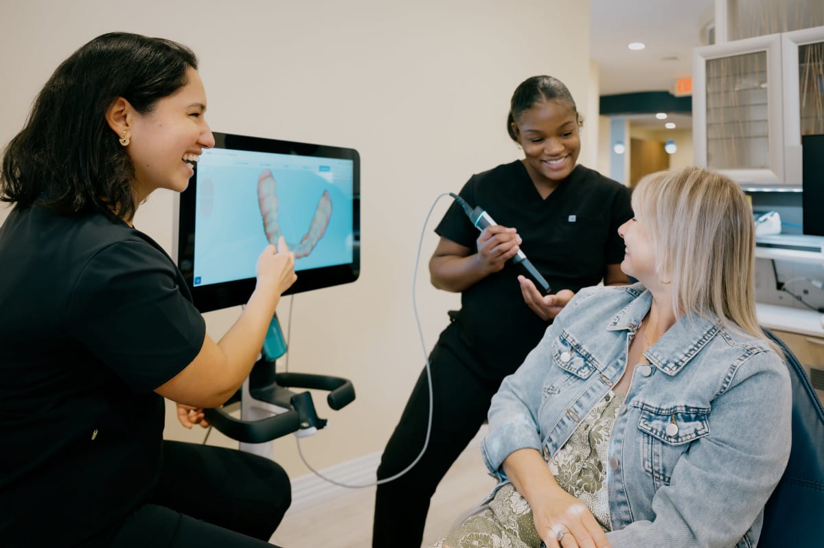 Dental professional consulting with patient about treatment options in clinical setting